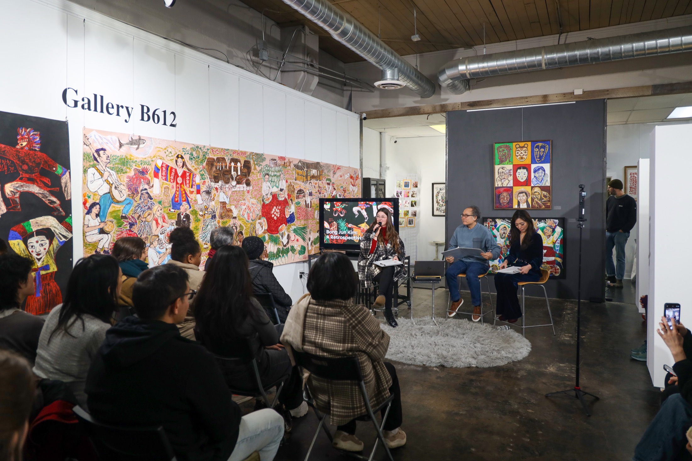 Audience members attending a public arts talk at Gallery B612.