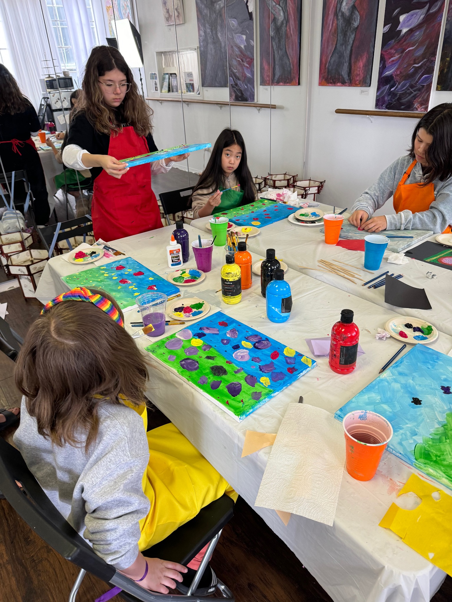 Young participants painting together during a Margolis Arts Foundation workshop.