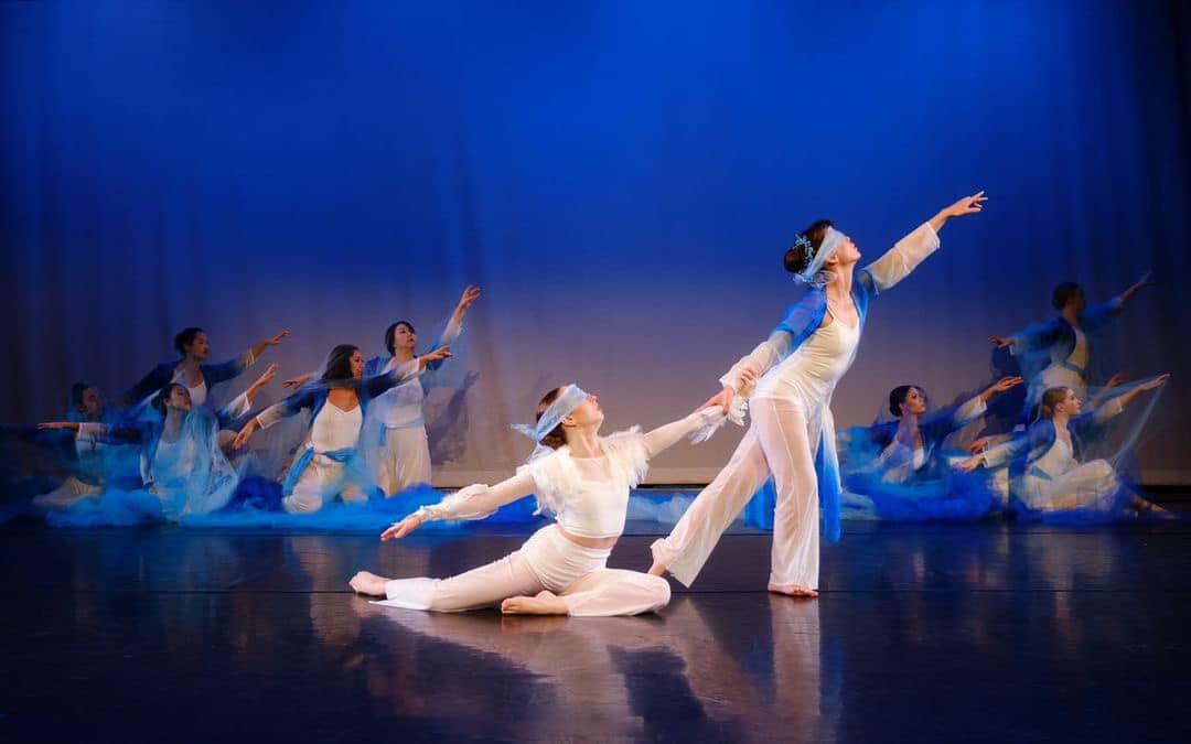 MiYoung Margolis Dance Collective performing in a blue-lit ensemble stage work.